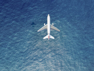 Airplane flies over a sea