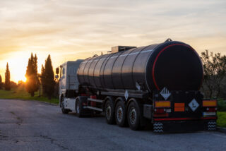 Tanker truck for the transport of dangerous goods parked at sunset.