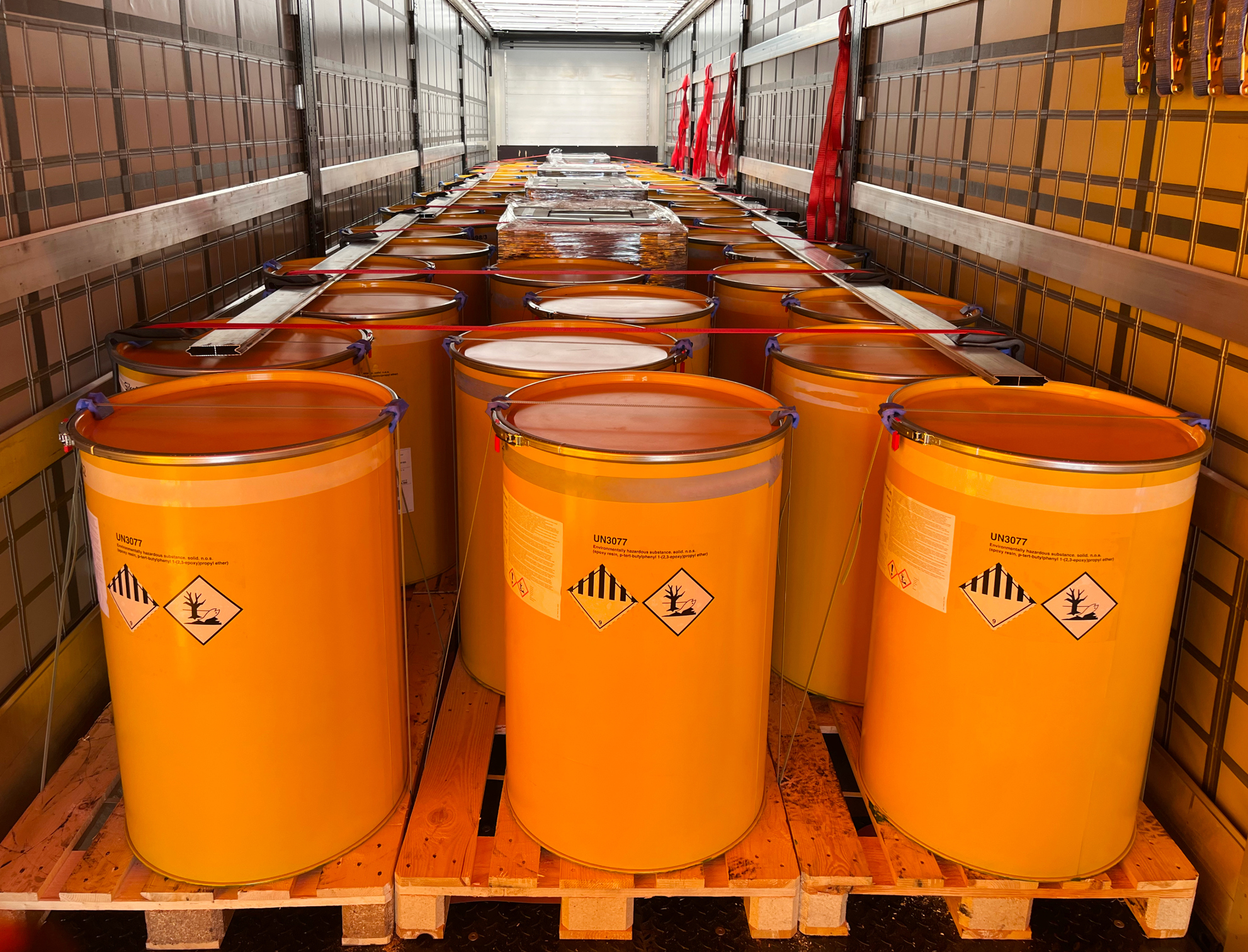 Loading, transportation and unloading of barrels with hazard class 9 in a semi-trailer. Transportation of dangerous goods by ADR cargo transport.